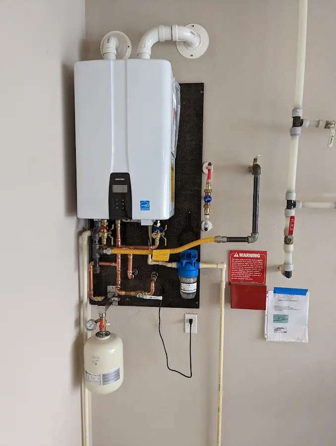 Professional plumber installing copper piping in a Westport home